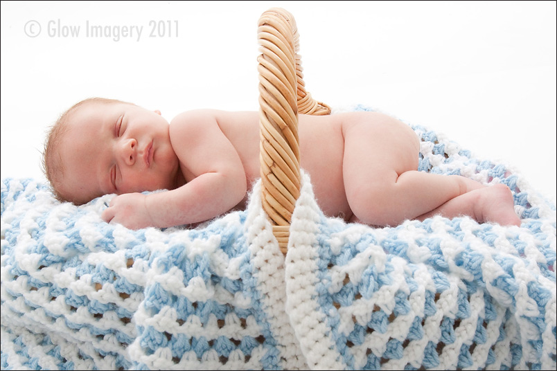 A photograph of Kansas City baby on top of his grandmother's knitted blanket